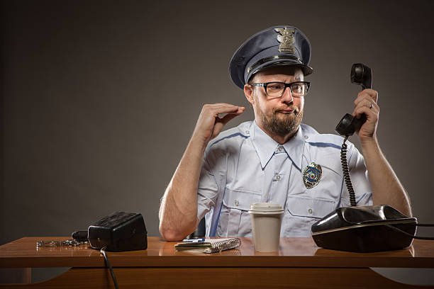 jefe de la federación de policía hablando por teléfono - desk police police station humor fotografías e imágenes de stock
