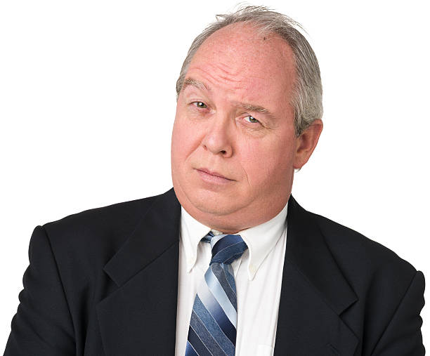 istock Uncertain Mature Man In Suit Raising One Eyebrow 174827267