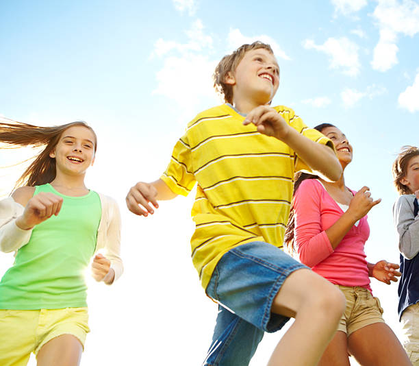 istock Kids running through the open field, smiling, excited 174827742