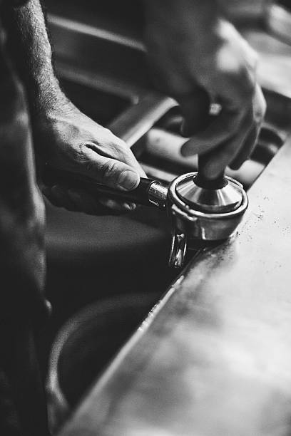 Barista with Espresso and Tamper in Cafe