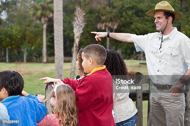Zoo Keeper With Group Of Children At Animal Exhibit Stock Photo - Download Image Now