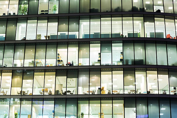 istock Illuminated office buildings in London 174828994