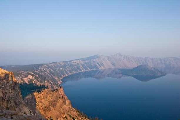 Sunrise from Mount Garfield Crater Lake exists in the blown-out caldera of a once mighty volcano known as Mount Mazama. This view of the lake at sunrise was taken from the Garfield Peak in Crater Lake National Park, Oregon, USA. jeff goulden crater lake national park stock pictures, royalty-free photos & images