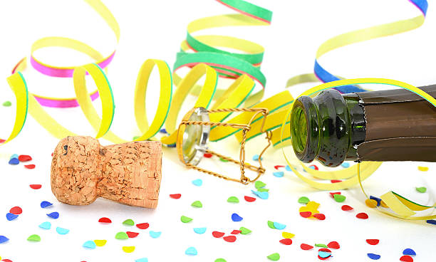 istock Champagne cork with bottle and confetti on white background 174829269
