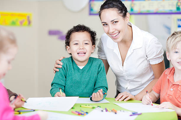 istock Teacher and daycare children 174829335