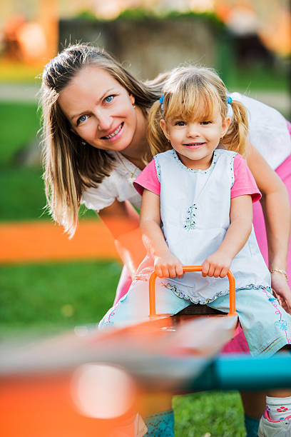 istock Mother with her daughter enjoying in playground 174829644