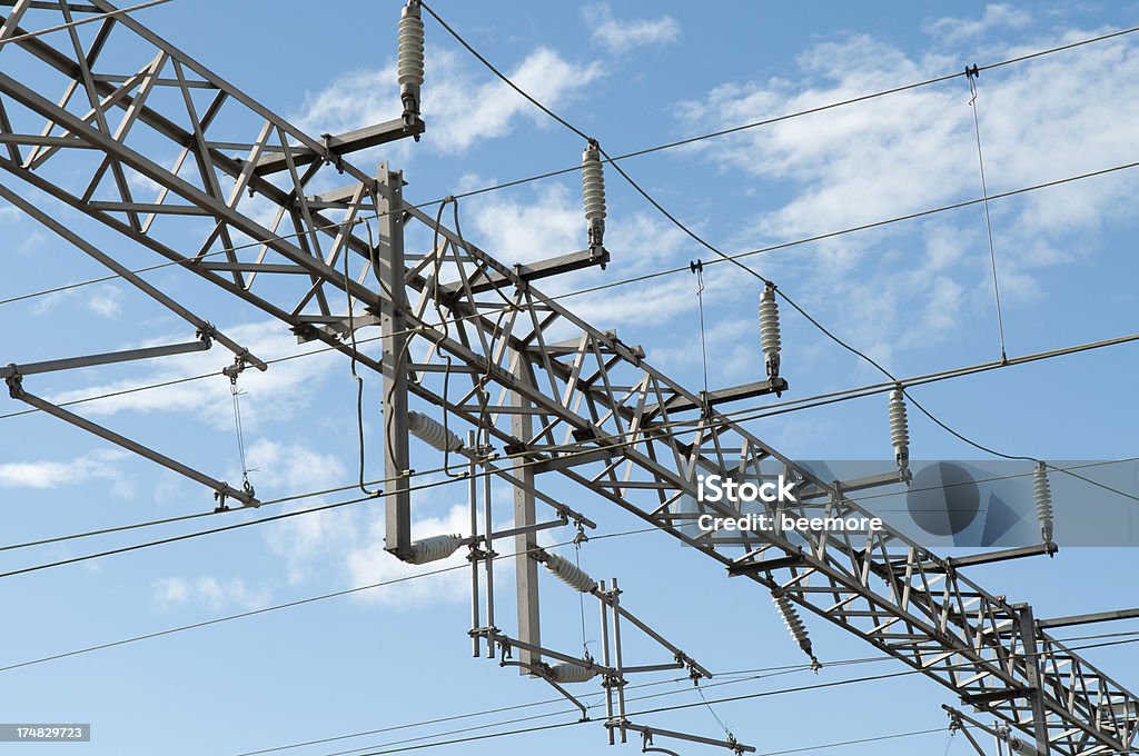 Railroad Electrical Power Supply Lines and Steel Transmission Tower Built Structure Stock Photo