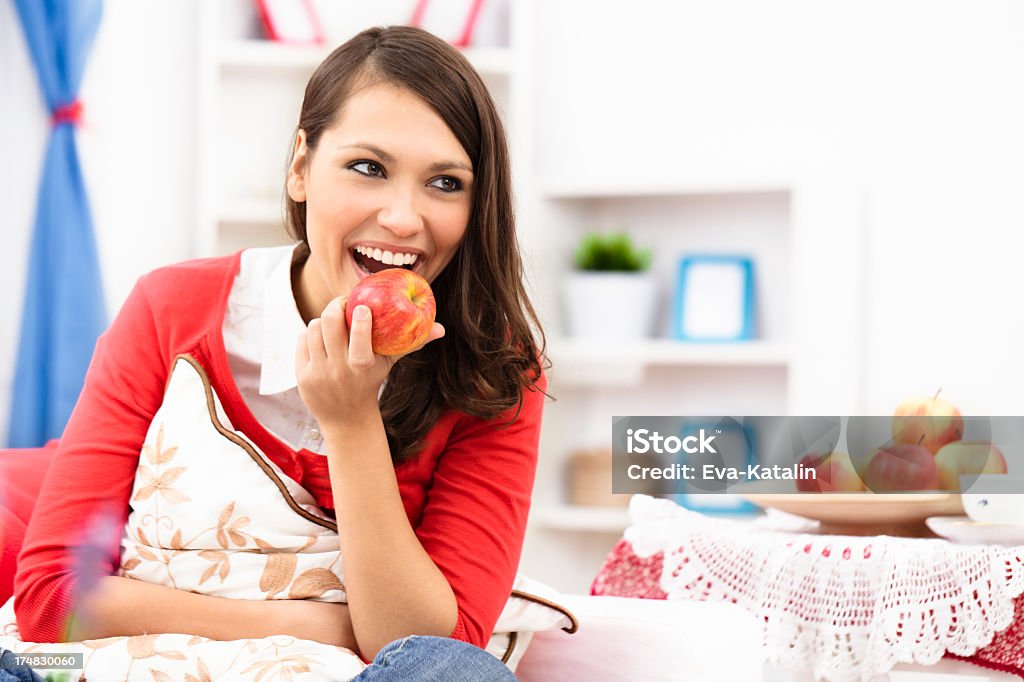 Enjoying a delicious apple Pretty young woman enjoying a delicious  apple 20-24 Years Stock Photo