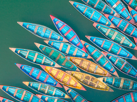 Aerial view of typical Nepalese boats moored along the lake shores of Begnas Lake, Lekhnath, Nepal