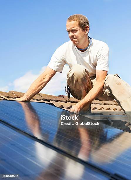 Saving The Environment One Panel At A Time Stock Photo - Download Image Now - Solar Panel, Building - Activity, Men