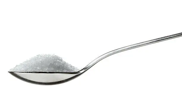 salt on spoon isolated on white