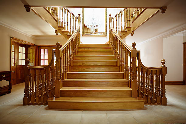 Entrance Hall with oak staircase Curved oak staircase in luxury home entrance hall stairwell chandelier stock pictures, royalty-free photos & images