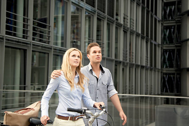 istock Young couple walking with bike 174831269