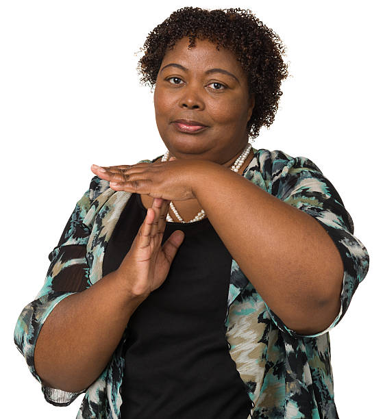Woman Gestures Time Out Hand Signal Portrait of a mature woman on a white background. time out signal stock pictures, royalty-free photos & images