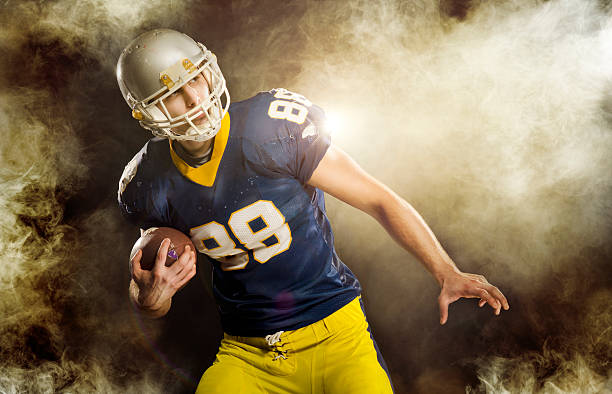 istock American Football play in smoke 174831366