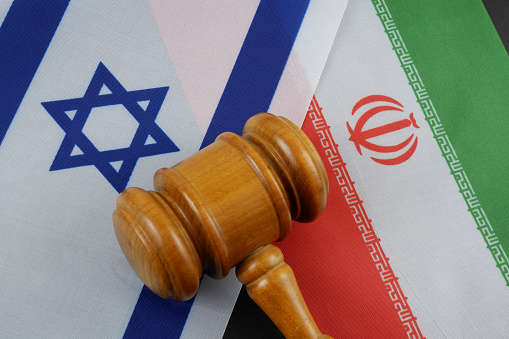 Judge gavel on Israel and Iran flags. Legal solution of Israel and Iran conflict.