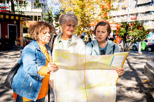 Mature women Travelers are Sightseeing the City During a Vacation Using a City Map