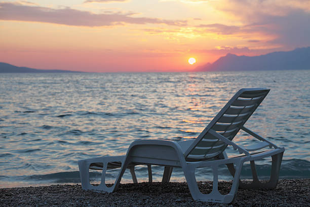 istock lonely single white plastic sunbed against mediterranean ocean sunset 174831705