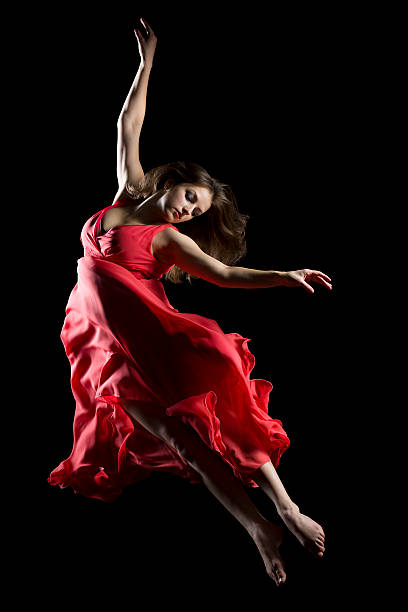 istock The dancer in midair on black 174831744
