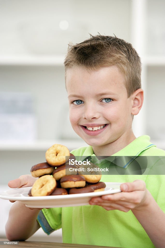 Little Boy with Tasty Treats Young happy smiley little boy with a plateful of treats Boys Stock Photo