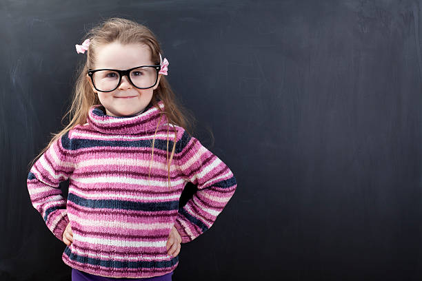 Cute girl in front of a chalkboard
