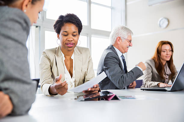 istock Business meeting... black woman checking data on digital tablet 174832031