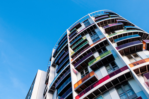 Modern colourful luxury apartments and balconies with a blue sky