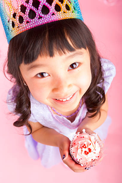 istock Young girl holding a cupcake 174832741