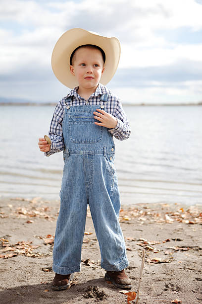 istock Little Boy Wearing Denim Overalls and Cowboy Hat 174833204