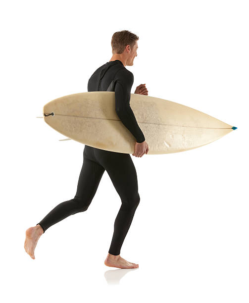 istock Smiling male surfer carrying a surfboard 174833592