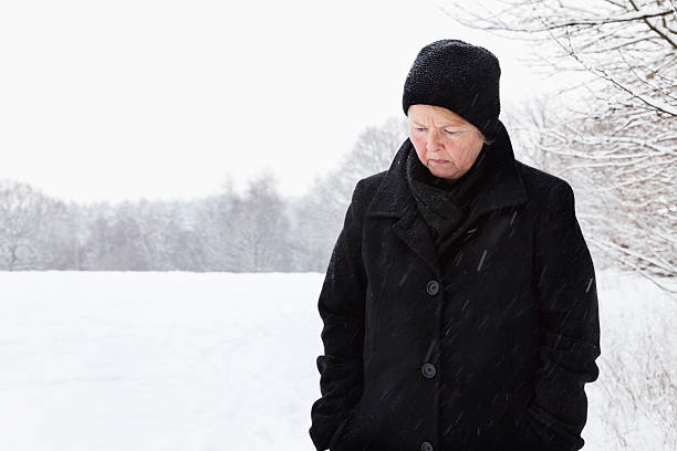 istock senior woman in winter sadness 174833779