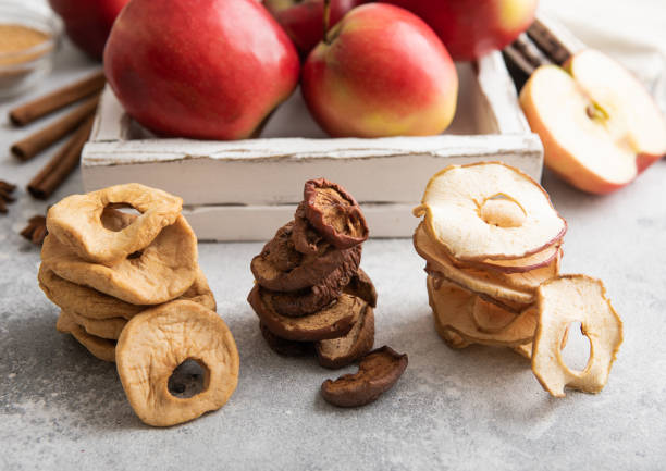istock Piles of assorted dried apple slices,chips and rings on light background.Macro. 1748338818