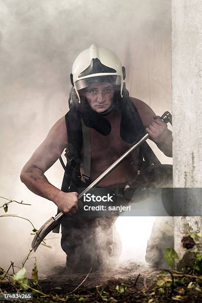 Fireman In Action Stock Photo - Download Image Now - Accidents and Disasters, Activity, Adult