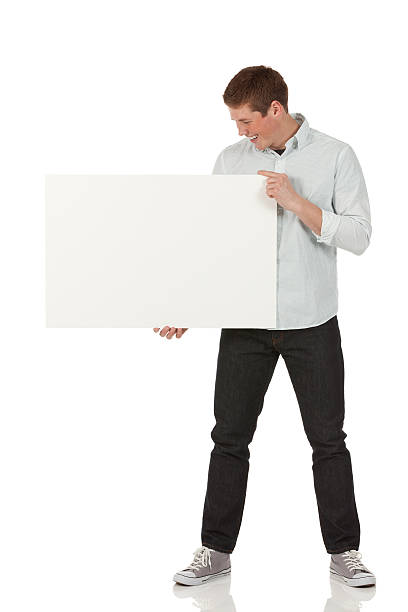 istock Smiling young man looking at a placard 174834275