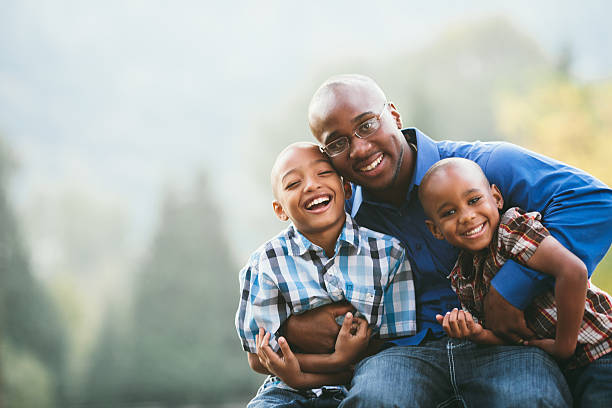 Young father with two sons Mid twenties african american father with his two young boys with copy space. single father stock pictures, royalty-free photos & images