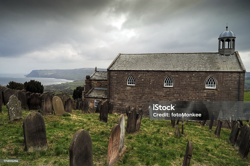 St. Stephen's Church, Robin Hoods Bay, North Yorkshire "Situated on its windswept hill above Robin Hoods Bay, old St Stephen's was built in 1821 and is particularly noted for its association with the sea and seamen. Weathered tombstones in the graveyard bear witness to the large number of seafarers buried there and plaques in the church record those who failed to make it safely home. Image taken on a late afternoon with storm clouds moving inland from the sea.More of my images from around Britain in this lightbox:" Architectural Feature Stock Photo