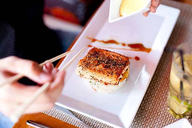istock Young men ready to eat roasted salmon 174835267