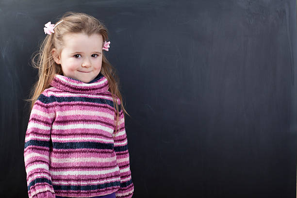 istock Cute girl in front of a chalkboard 174835765