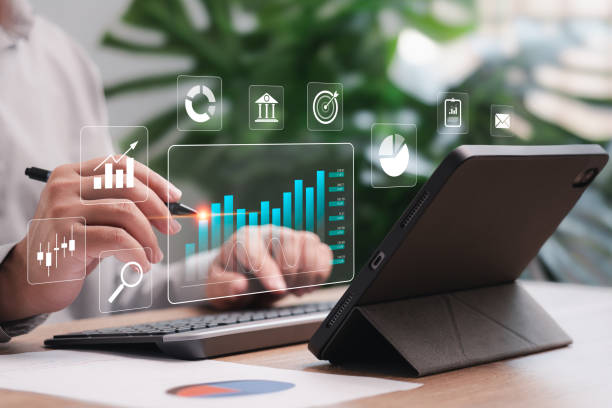 istock Business Analytics Data Management of finance work report concept, Businessman use tablets to show report graphs on the virtual screen, make a report with KPI and metrics, strategy for marketing 1748360382