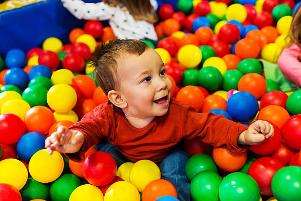 istock Cute little boy playing in the ball pool. 174836125