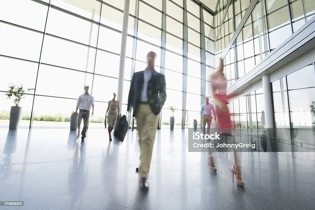 Business People Walking In Office Blurred motion of business people walking in office. 20-29 Years Stock Photo