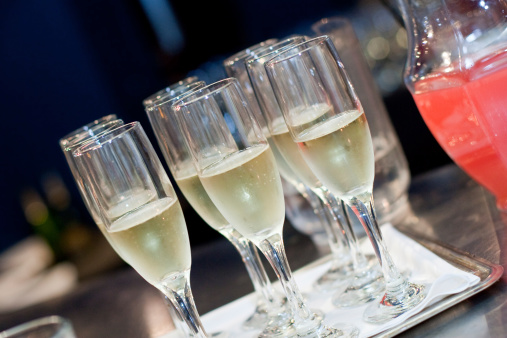 A tray of champagne in flutes at a reception.