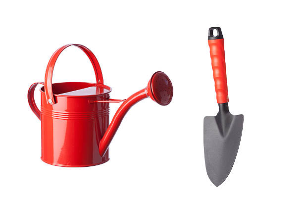 istock Red watering can and shovel on white background 174836421