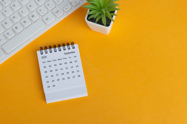 istock September 2024 desk calendar on yellow background. Directly above. Flat lay. 1748367973