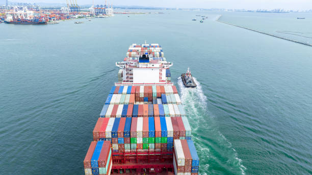 istock Cargo container ship carrying container and running with tug boat for import goods to cargo yard port to customs. concept logistics transportation and shipping. 1748370766