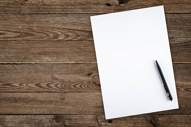 istock Pen sitting on a blank white piece of paper. 174837331