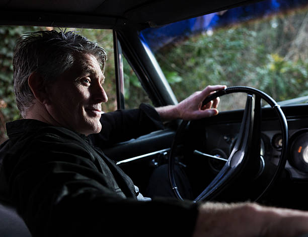 istock Senior Man in a Classic Car 174837548