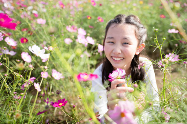 istock girl playing in a flower field 1748376707