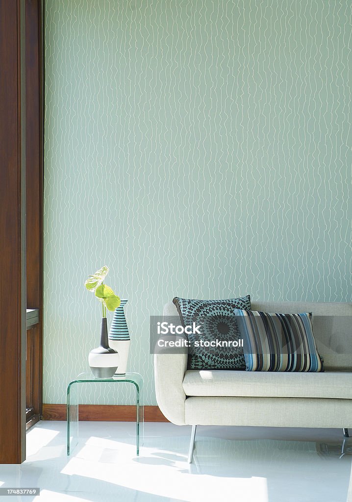 Interior of stylish sofa in a modern livingroom Interior of stylish cream sofa with cushions in a modern livingroom Living Room Stock Photo