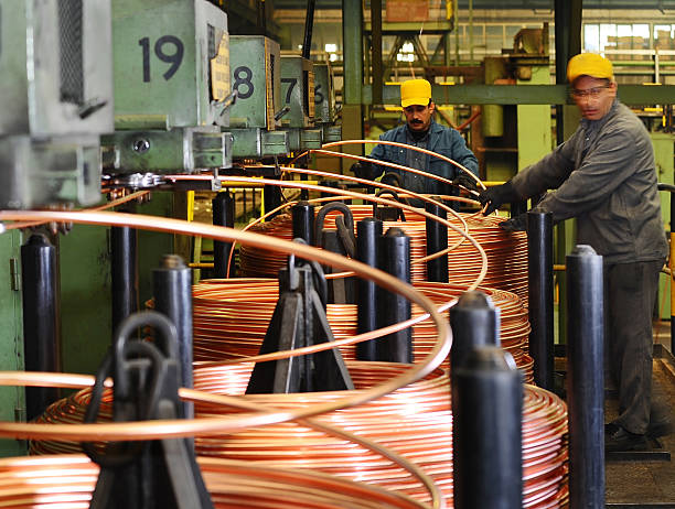 istock Workers checking quality of copper pipes 174837867
